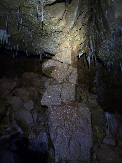 A Tottering Pile Of Rock Held Up By A Straw