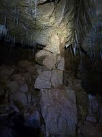 A Tottering Pile Of Rock Held Up By A Straw